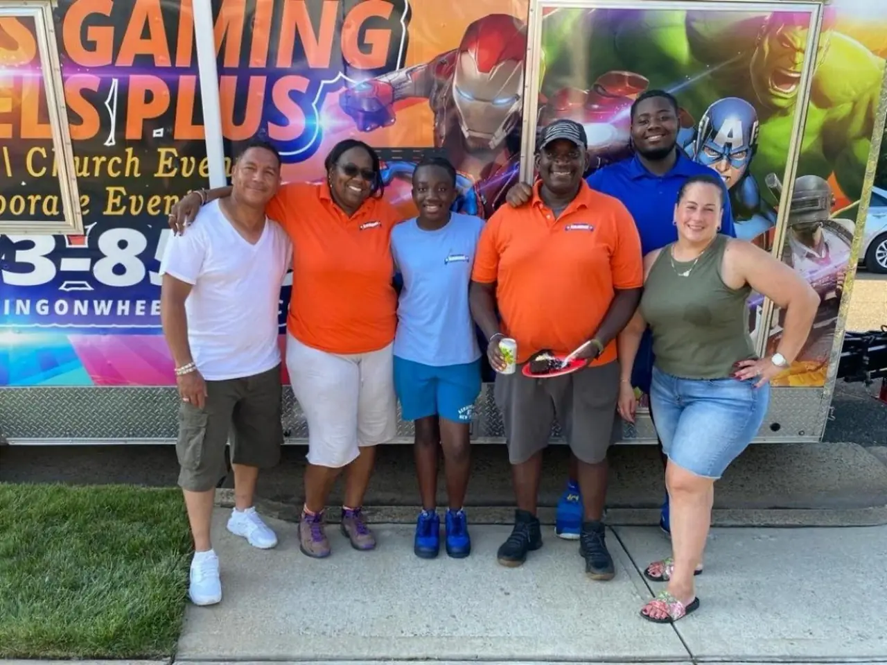 Family celebrating in front of the gaming trailer