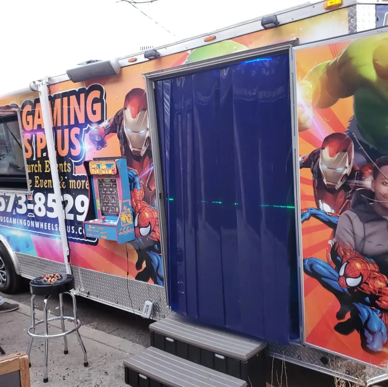 Entrance to the luxury gaming trailer with superhero wrap