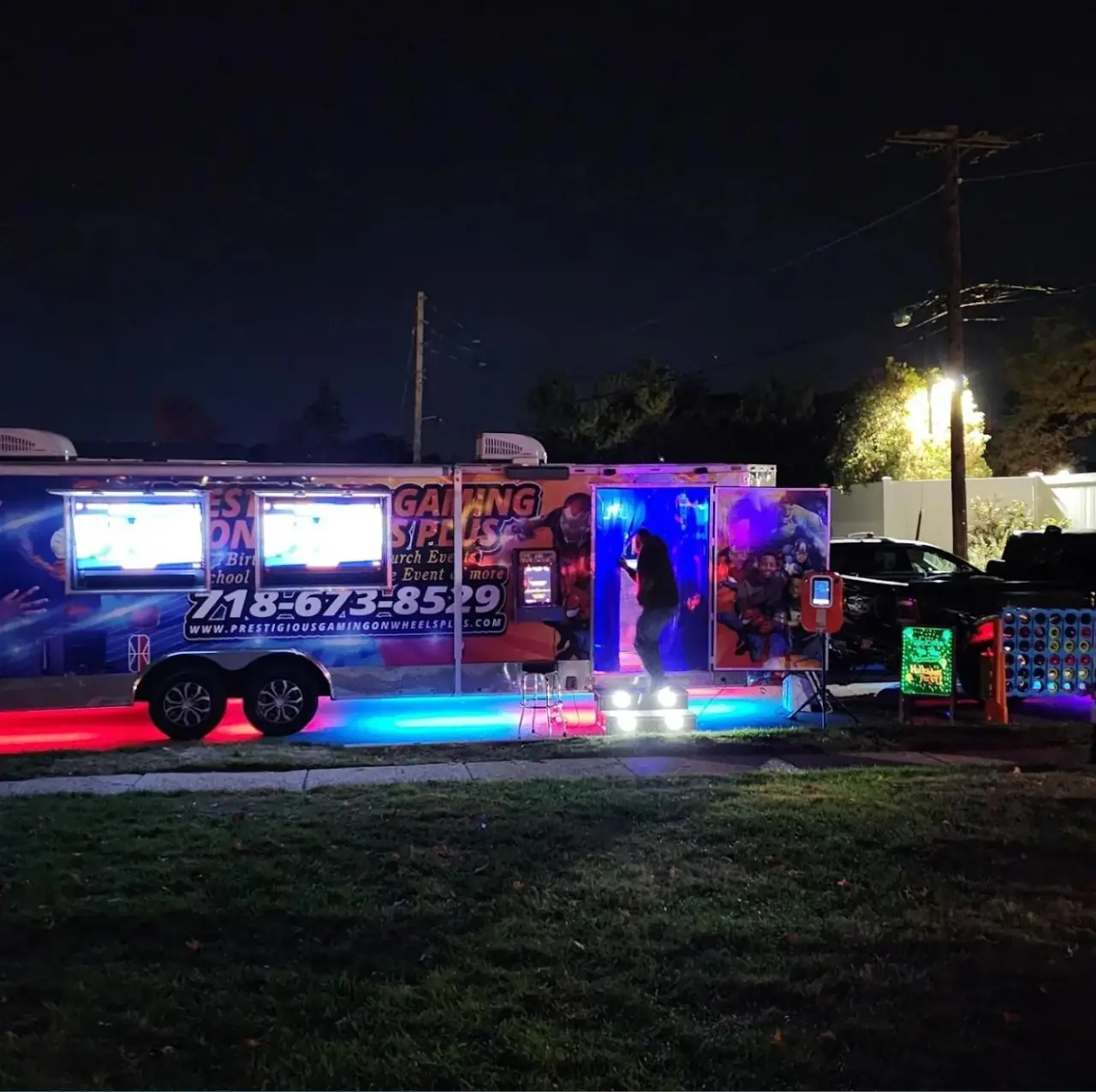 Game trailer with neon underglow set up for an evening birthday party